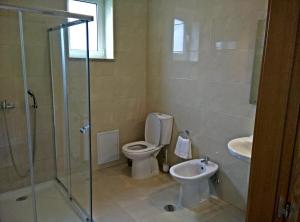 a bathroom with a toilet and a sink at Agroturismo A Fidalga in Linhares