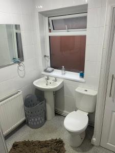 a bathroom with a toilet and a sink at Charlies in Skegness