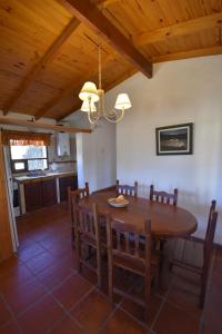 a dining room with a wooden table and chairs at Cabañas Río Molle in Tafí del Valle