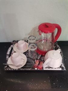 a tray with dishes and a blender on a table at Sunset View Palace Guest House in Soshanguve