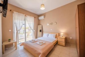 a bedroom with a large bed and a window at Katerina's House in Afantou