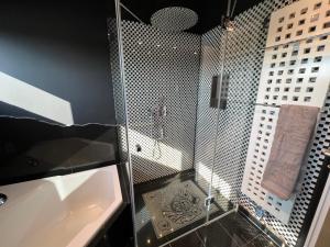 a bathroom with a glass shower and a sink at Luxus Loft über den Dächern von Roding in Roding