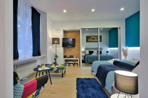 a hotel room with two beds and a living room at Aurea City Center Apartment Zagreb in Zagreb