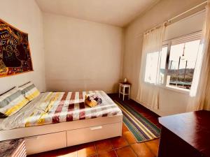 a bedroom with a bed and a window at Casa Maca, espectacular casa con piscina y vistas in Olivella +14 photos