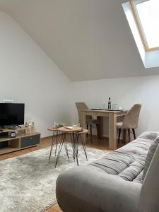 a living room with a couch and a table at Despot apartmani in Mladenovac
