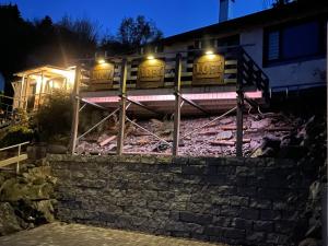 a train on tracks in front of a building at night at LOFT Ferienhaus Fischer in Goldkronach