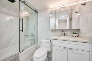 a bathroom with a toilet and a shower and a sink at Drake950 in Vancouver