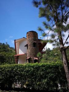 a building with a tower on the side of it at Casalta, Hermosa casa de arquitectura Rústica in Sorá