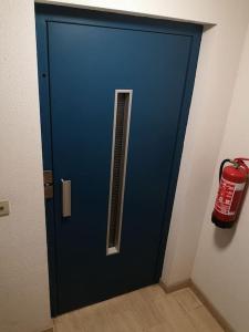 a blue door in a room with a fire hydrant at Duinenzicht in Middelkerke