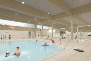 a group of people swimming in a swimming pool at Duinenzicht in Middelkerke