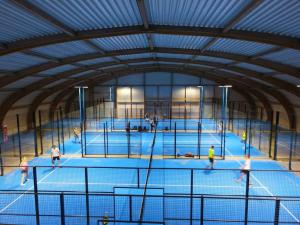 a group of people playing tennis on a tennis court at Duinenzicht in Middelkerke