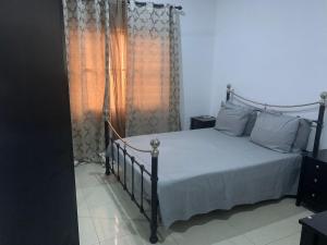 a bedroom with a bed and a window at Cheerful 3 bedroom bungalow, Fatty Boulevard in Madina Sey Kunda