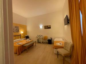 a room with two beds and a table and chairs at AD Cavour Luxury Rooms - by AD Roma in Rome