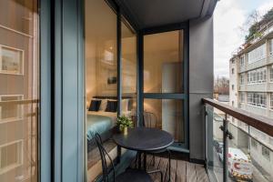 ロンドンにあるFarringdon Apartmentsのテーブル付きのバルコニー、ベッドルーム1室が備わります。