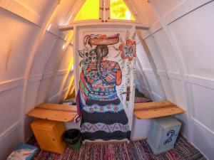 a room in a tiny house with a painting on the door at Elrayga Camp Dahab in Dahab