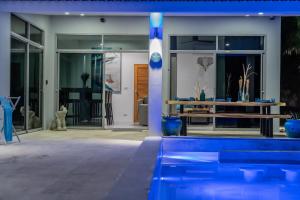 a house with a swimming pool with blue vases at VILLA ARGANDA Infinity Pool Luxury Sea View in Bophut