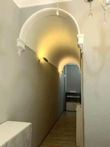 a hallway with an archway in a room at AmoRoma Vatican in Rome