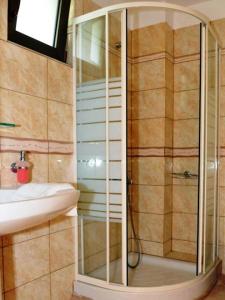 a bathroom with a shower and a sink at Finiki Plaza in Methoni