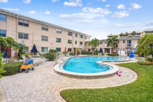 a swimming pool in front of a building at Friendly Native 507 in St Pete Beach