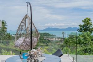 a hanging hammock on top of a table at VILLA ARGANDA Infinity Pool Luxury Sea View in Bophut