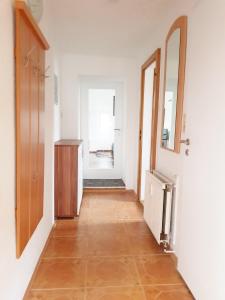 a hallway with a mirror and a dresser in a room at Haus Ajax in Anklam