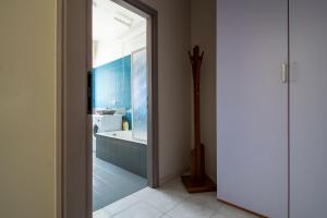 a bathroom with a bath tub and a sink at Happy Home in Saronno
