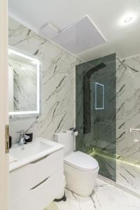 a bathroom with a white toilet and a sink at Downtown Core Apartments in Budapest