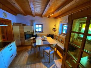 a kitchen and dining room with a table and chairs at Ferienhaus Falbeson in Neustift im Stubaital