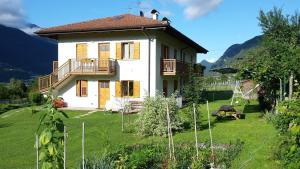 a house with a large yard in front of it at Villa Irma in Levico Terme