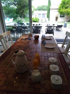 una mesa con una tetera y bebidas en ella en Les Hôtes du Paradis, en Forges