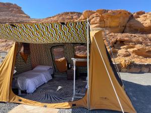 a yellow tent in the middle of the desert at Rural tents Naseem الخيمةالريفيةAlouzaib in Al Ula