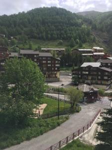 - une vue sur une ville avec des bâtiments et une montagne dans l'établissement La Foux D’Allos - Studio cosy - pied des pistes, à Allos