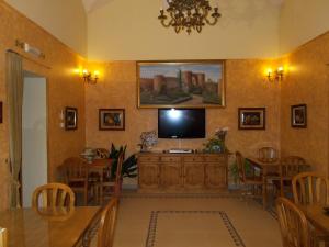 a living room with a flat screen tv on a wall at Hostal Mirador de Avila in Ávila