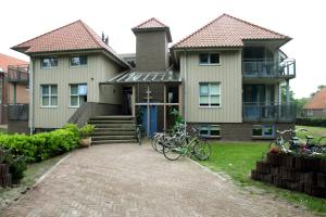 
a house with a bike parked in front of it at Hotel Bornholm in West-Terschelling
