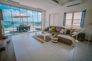 a living room with a couch and a table at Valletta Dream Penthouse in Valletta