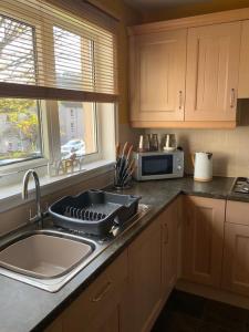 a kitchen with a sink and a counter top at Home from home, 3 bedroom house in Hawick in Hawick