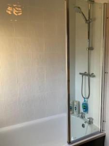 Home from home, 3 bedroom house in Hawick في هاويك: حمام مع دش وحوض استحمام مع حوض