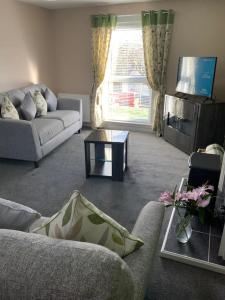 a living room with a couch and a table at Home from home, 3 bedroom house in Hawick in Hawick