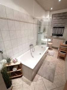 a large bathroom with a tub and a sink at FeWo in Nähe zum Sachsenring am Fuße zum Erzgebirge 