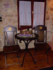 two chairs and a table with a table and two chairs at Sponsor of the E4 Peloponnese Trail in Daras