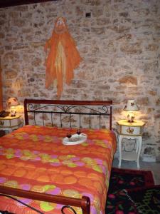 a bedroom with a bed and two tables with lamps at Sponsor of the E4 Peloponnese Trail in Daras