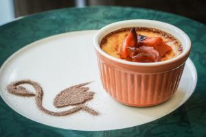 a cup of coffee on a plate on a table at Flamingo Grand Hotel & Spa in Albena