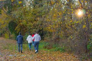 three people walking down a path in the woods at Flamingo Grand Hotel & Spa in Albena