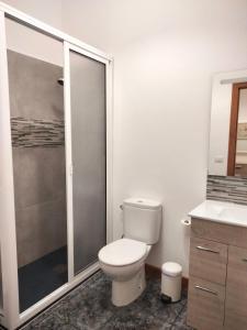 a white bathroom with a toilet and a shower at Amaba TENERIFE in La Guancha +9 photos