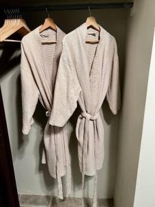 three towels are hanging on a rack in a closet at 2-BR Modern Oceanfront Apt Steps from Playa Sucia in Cabo Rojo