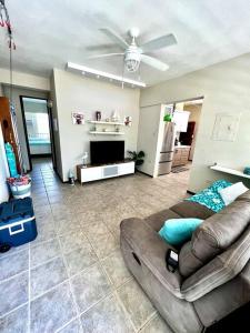 a living room with a couch and a ceiling fan at 2-BR Modern Oceanfront Apt Steps from Playa Sucia in Cabo Rojo