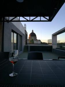 a glass of wine sitting on top of a table at Depto. en Costanera frente al rio 2 a 4 personas in San Nicolás de los Arroyos