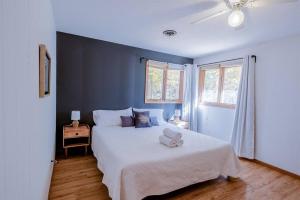 a bedroom with a white bed and a blue wall at Fall Getaway Resort-3 KING suites, Dog-Friendly in Seeley