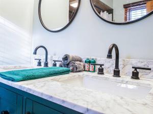 a bathroom with a sink and a mirror at Fall Getaway Resort-3 KING suites, Dog-Friendly in Seeley