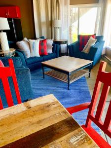 a living room with a blue couch and a table at Oceanhouse in Homer